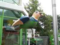 Sparrow of a sparrow with a plunger and tools sitting on a toilet