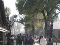 Auschwitz entrance gate with ironwork reading &ldquo;Arbeit macht Frei&rdquo;