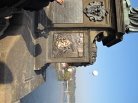 Plaque with shiny priest